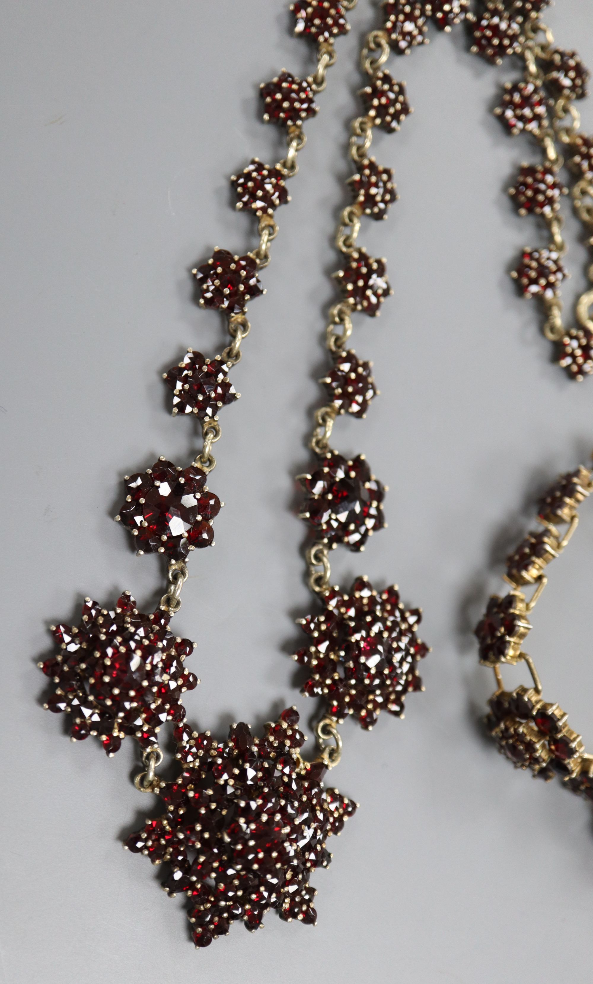 A 19th century gilt white metal and facet cut garnet set bracelet and similar necklace, 40cm.